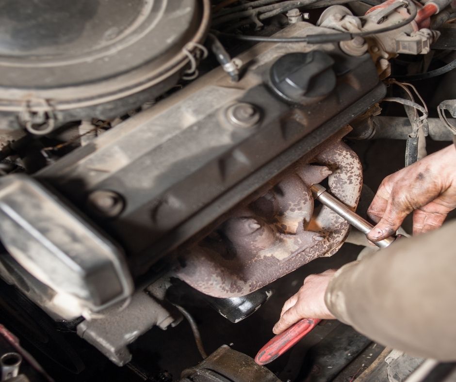 cracked stock diesel exhaust manifold showing heat damage and leaks